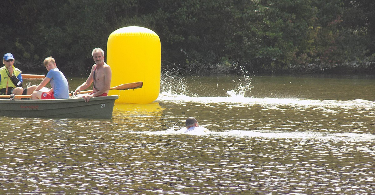 Wasserwachts-Chef Walter Brinkhoff (rechts) und ein Schiedsrichter leiten einen falsch schwimmenden Teilnehmer auf die richtige Bahn